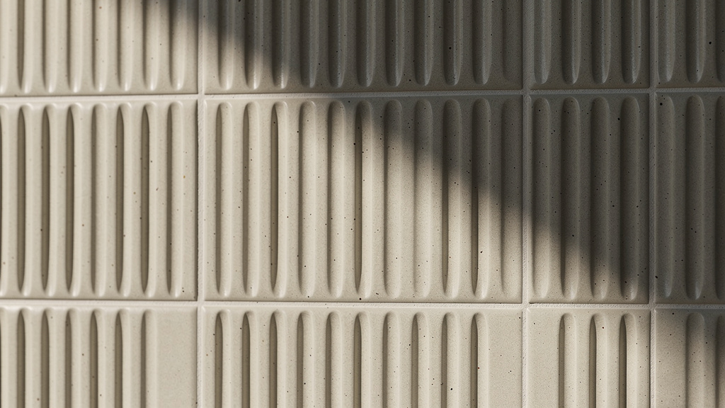 Three-dimensional fluted tiles creating depth through shadow and texture