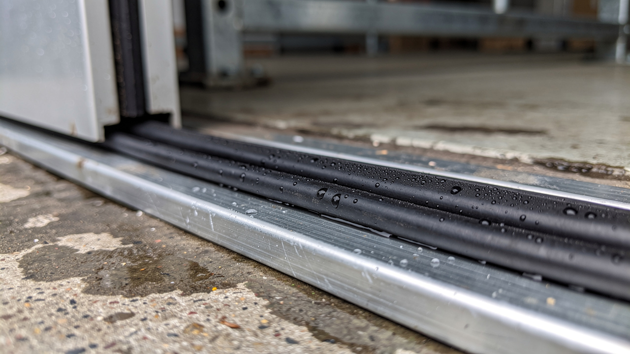 Heavy-duty rubber door seal compression detail