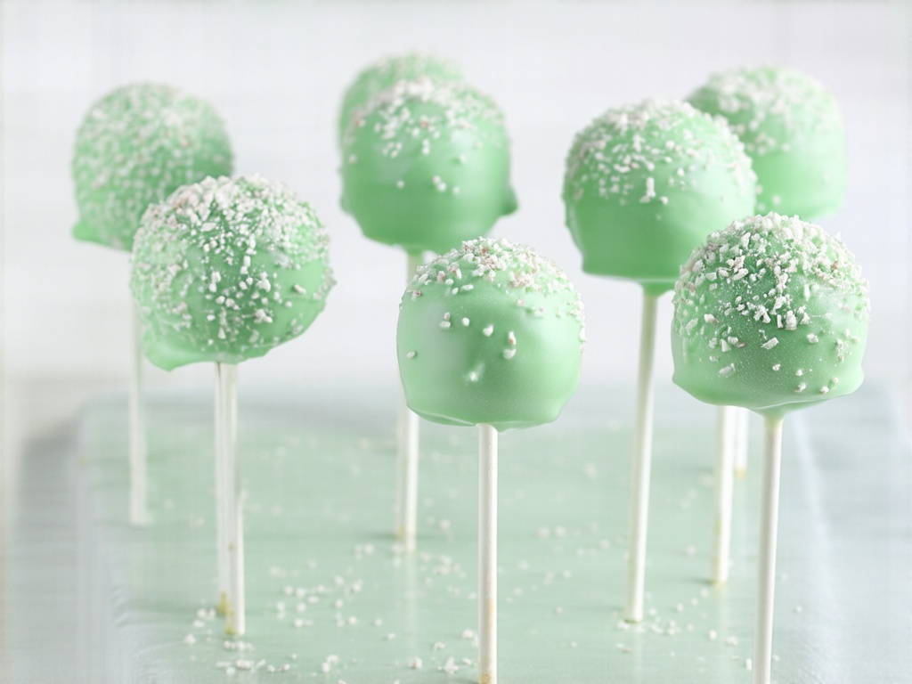 Mint cake pop ingredients showing fresh leaves, chips, and extract layers