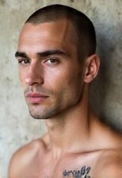 a-muscle-bound-fair-skinned-man-with-calm-dark-inx8ddat4h