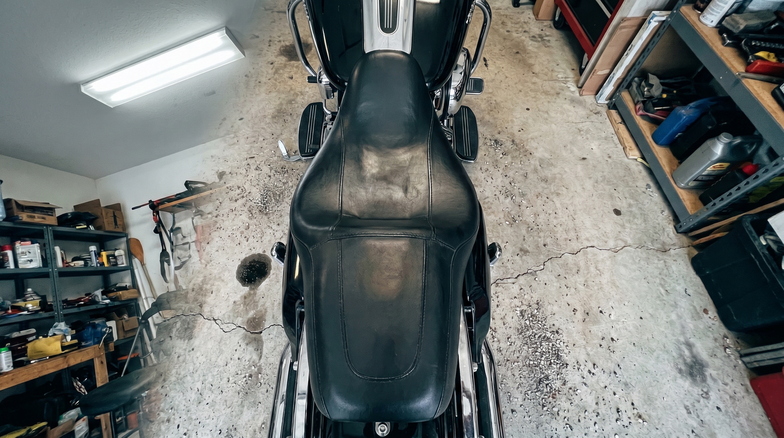Close-up of a Harley Street Glide factory vinyl seat surface showing firm flat seating area under bright garage lighting