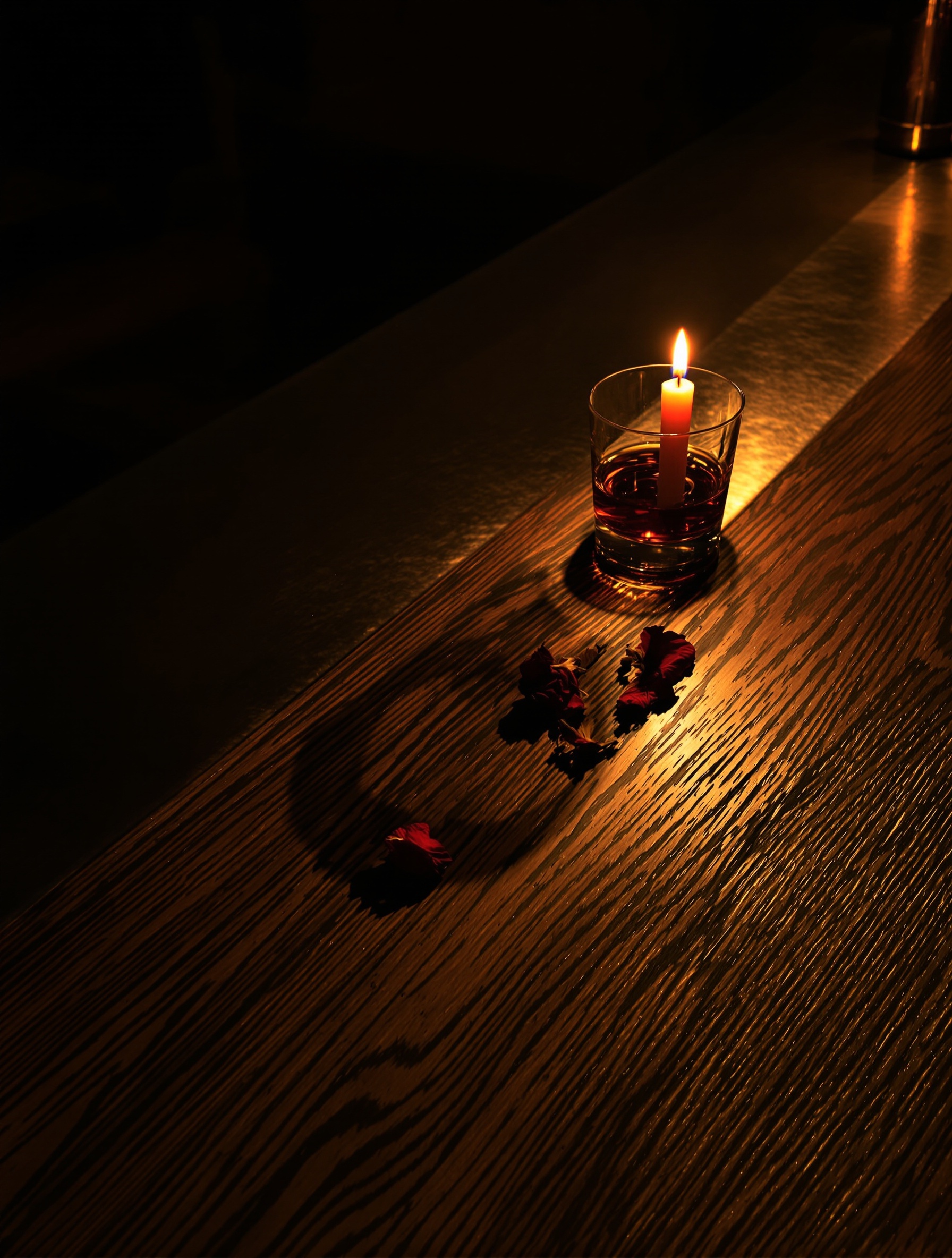 Candlelit amber light cast through a whiskey glass onto a dark wooden bar floor, the visual soul of Baraonda.