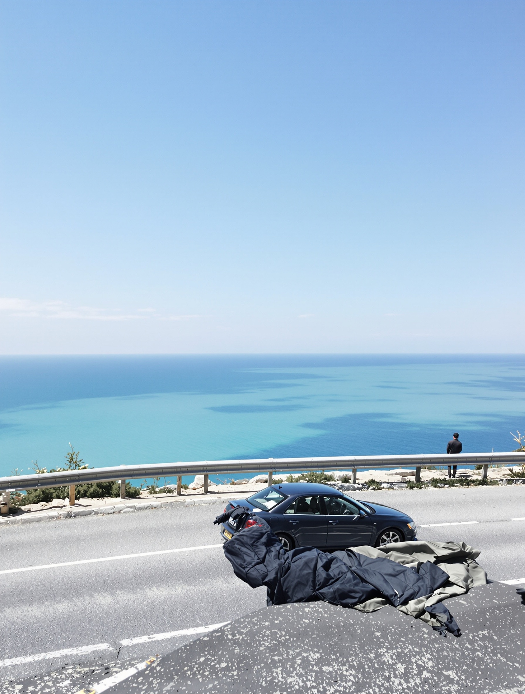 A lone figure at a coastal guardrail looking over pale Mediterranean sea evoking Louis Vuitton Imagination.
