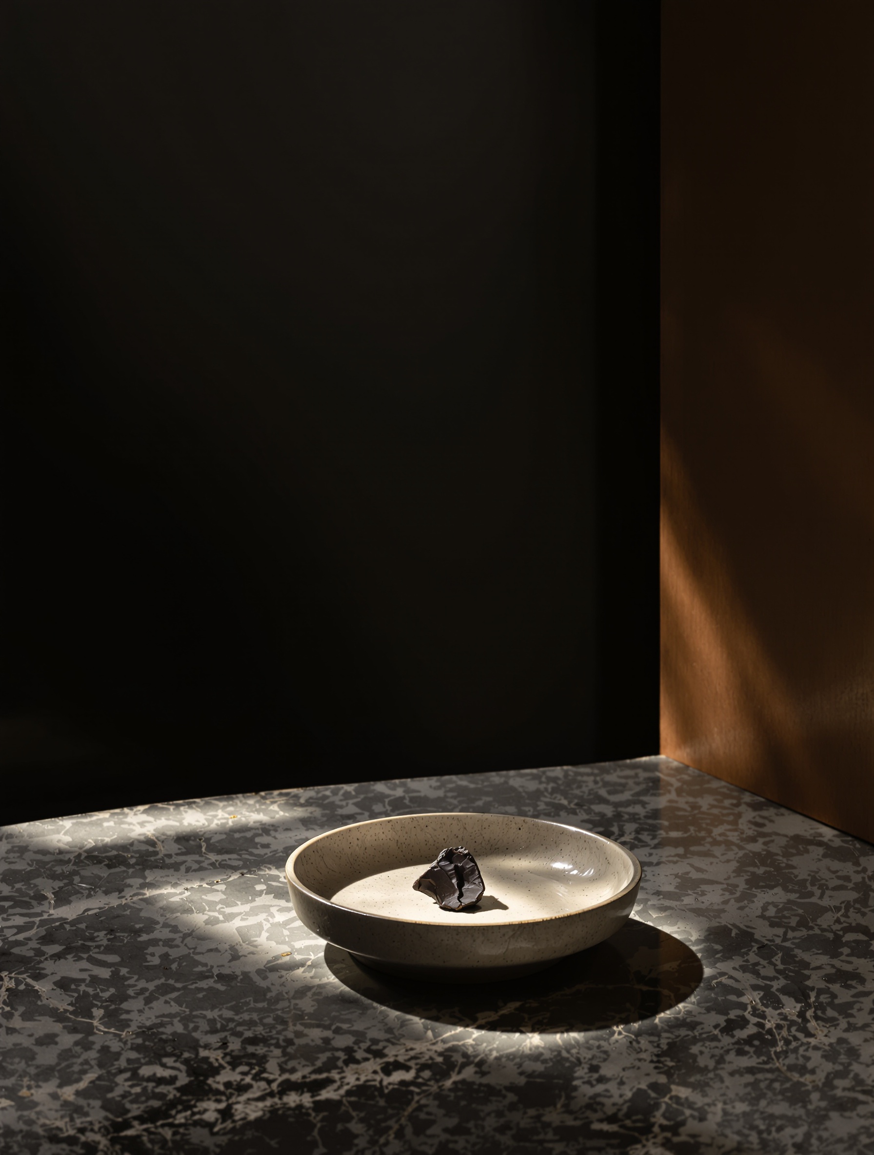 A raw kinam wood chip on an unglazed ceramic tray lit by a single shaft of cold morning light inside a dim wooden room, conjuring the kodo ceremony at the heart of Jasper No Kodo 2 by Folkwinds.