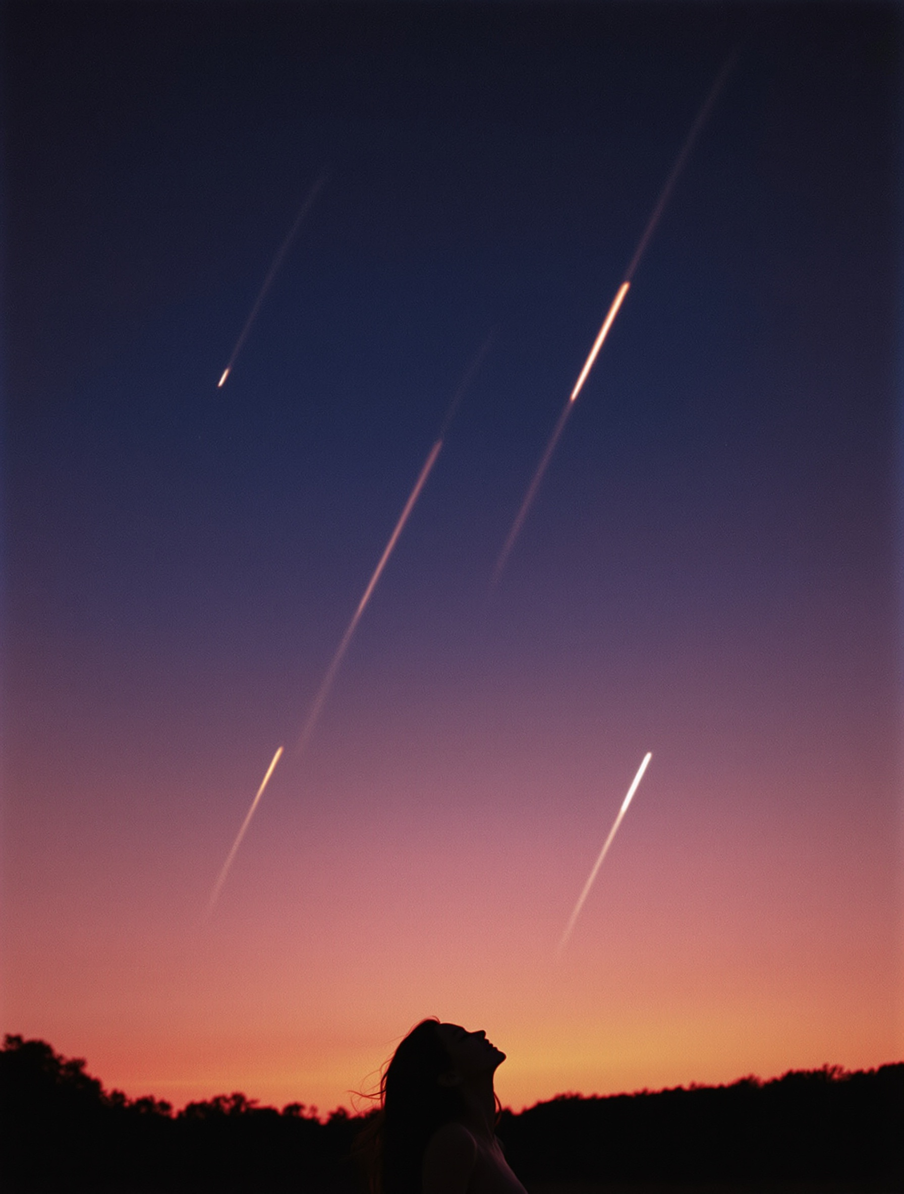 A woman seen from behind gazes up at a meteor shower over a summer field, evoking the fleeting euphoria of Attrape Rêves.