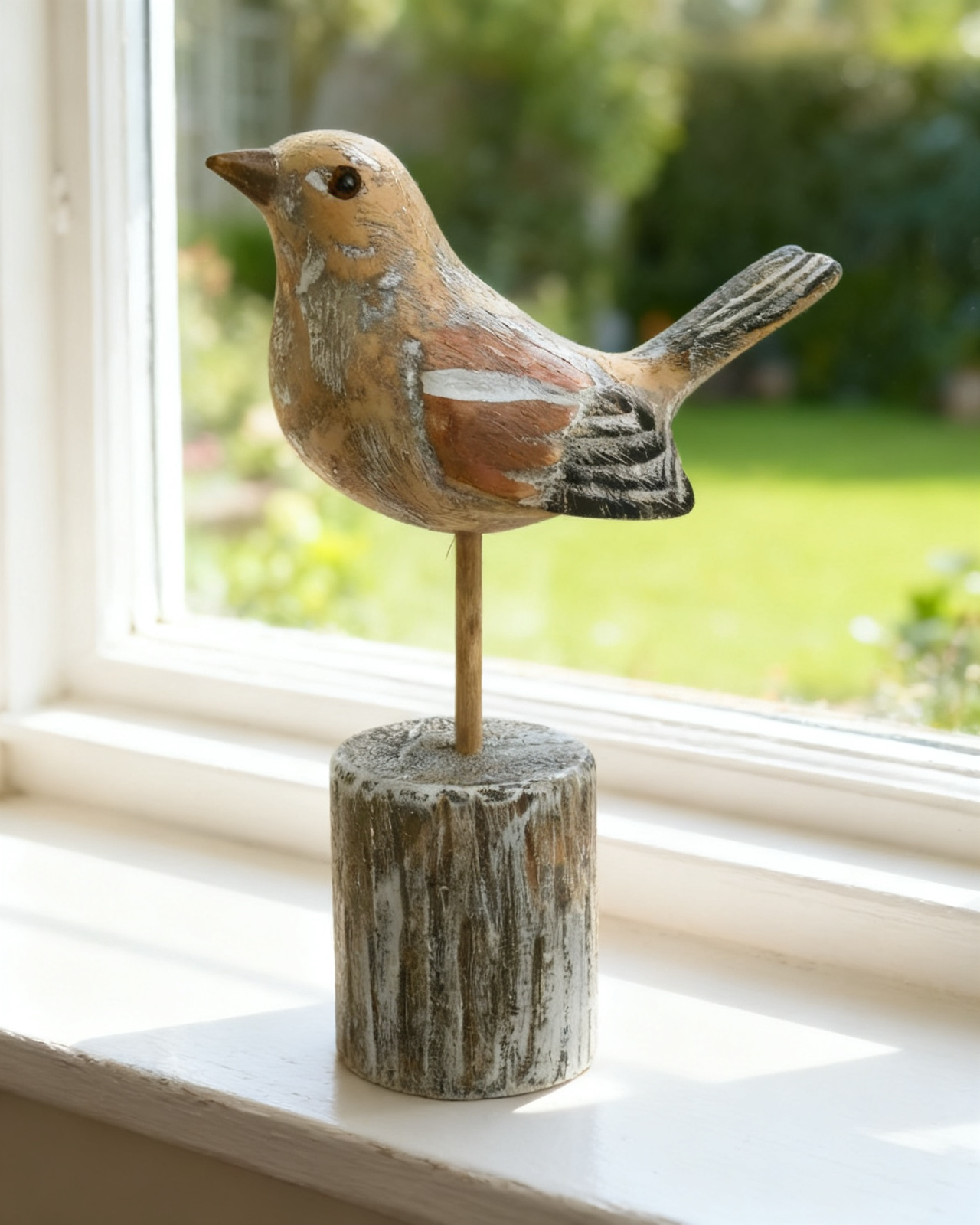 Hand-carved wooden chaffinch on a turned lime post