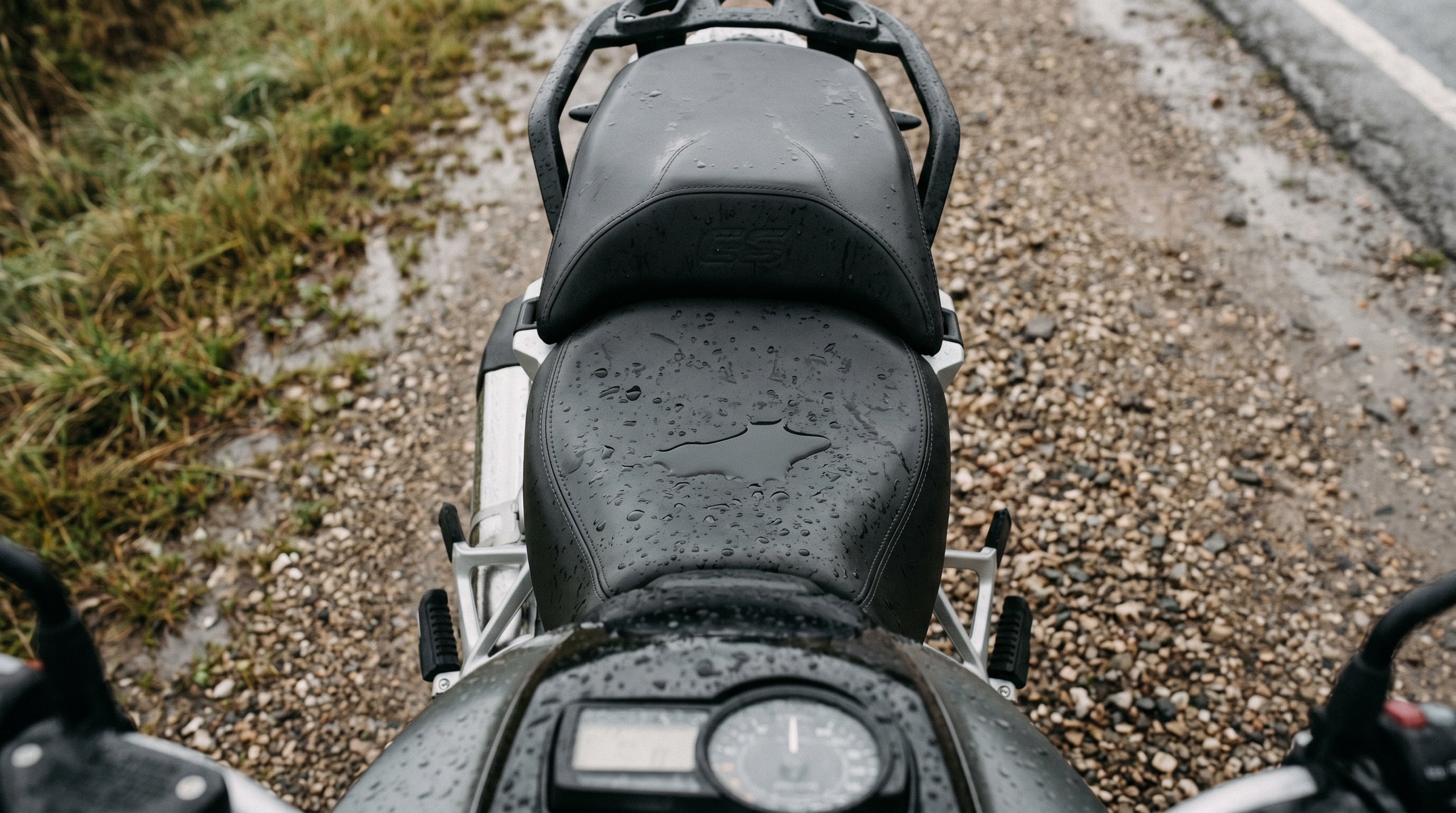 Rain pooling on a soaked factory vinyl motorcycle seat showing why a wet seat ruins the next stretch of road