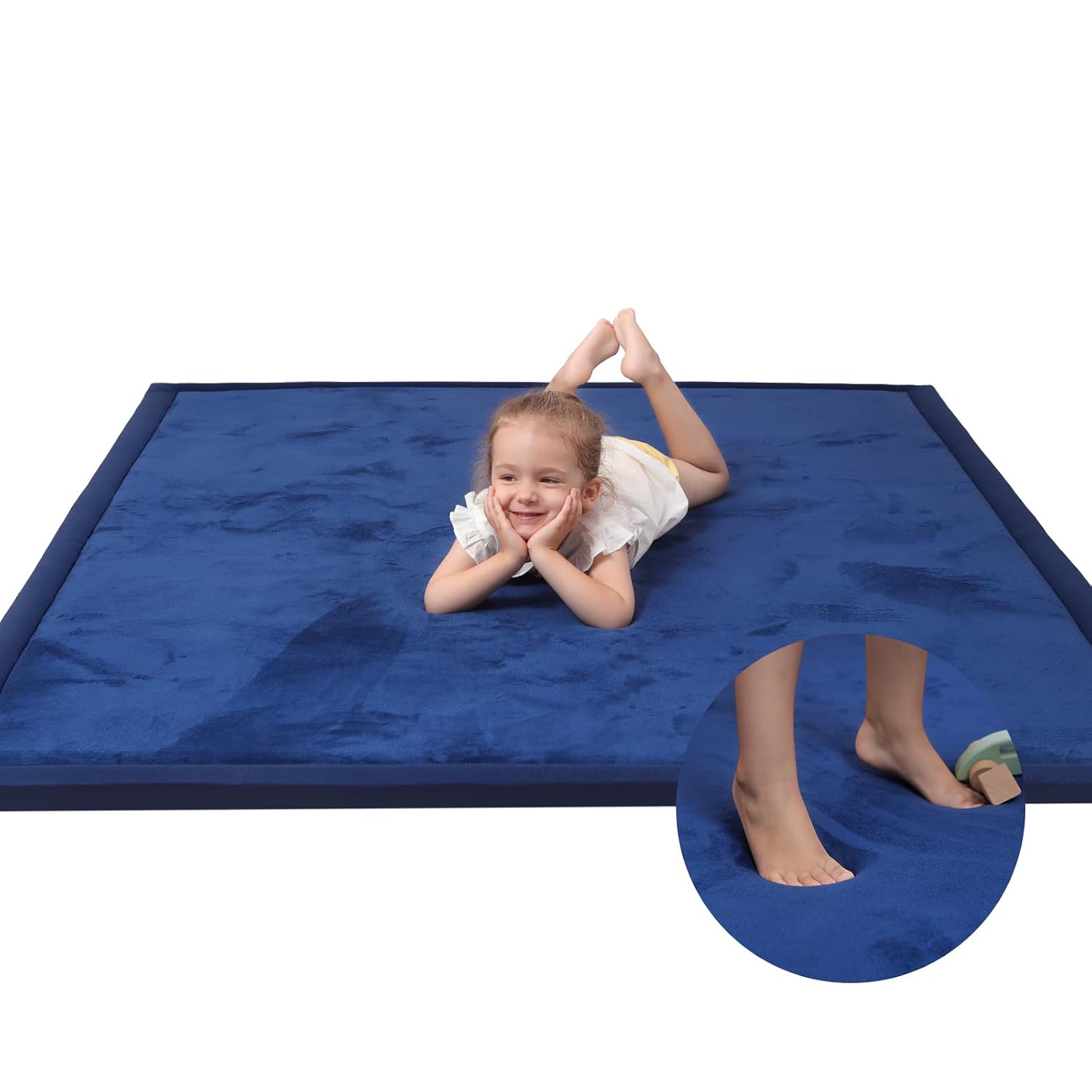 Macro close-up of royal blue velvet baby play mat texture showing soft pile detail