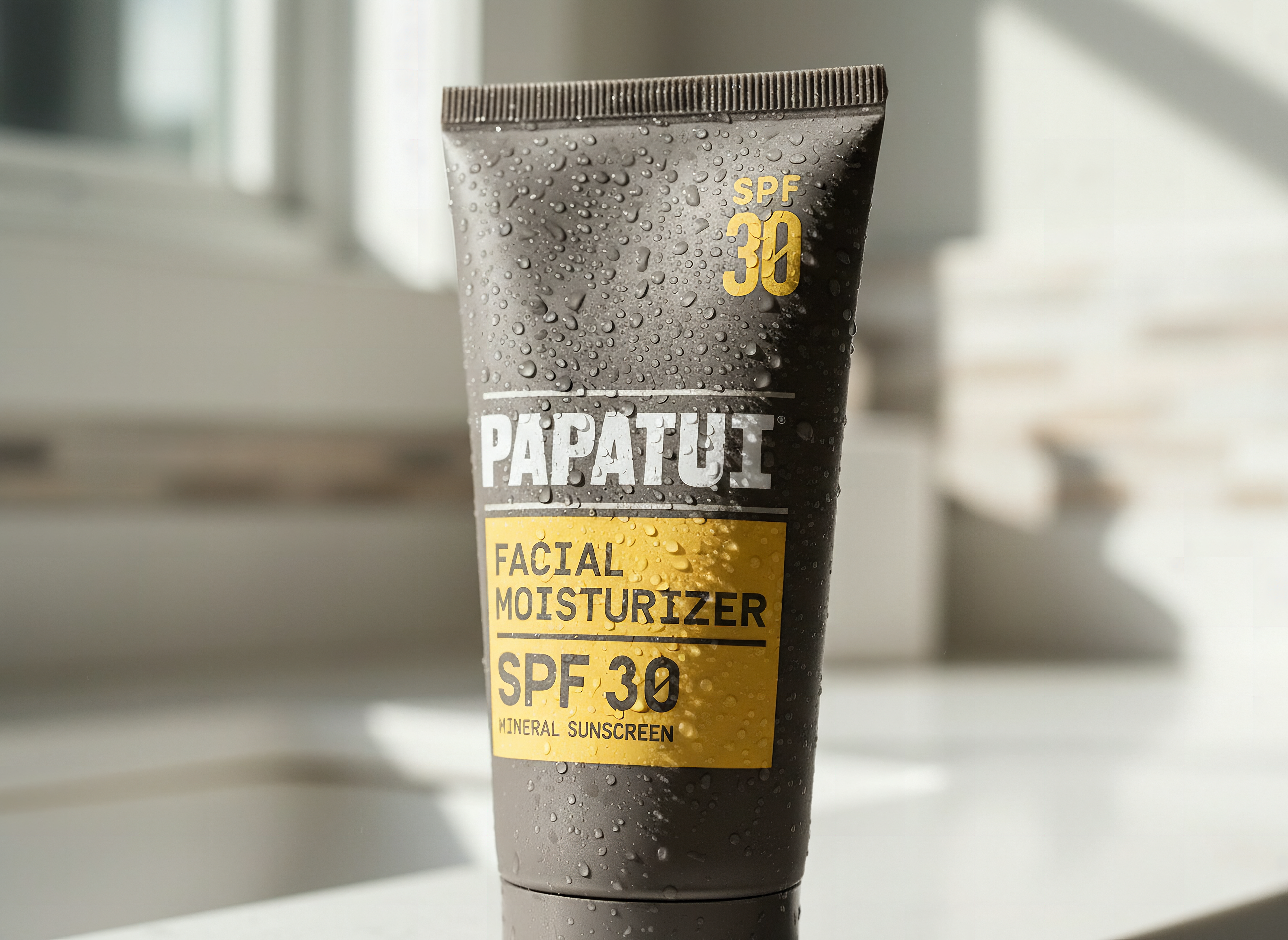 PAPATUI moisturizer bottle in extreme close-up with water droplets and soft bathroom lighting