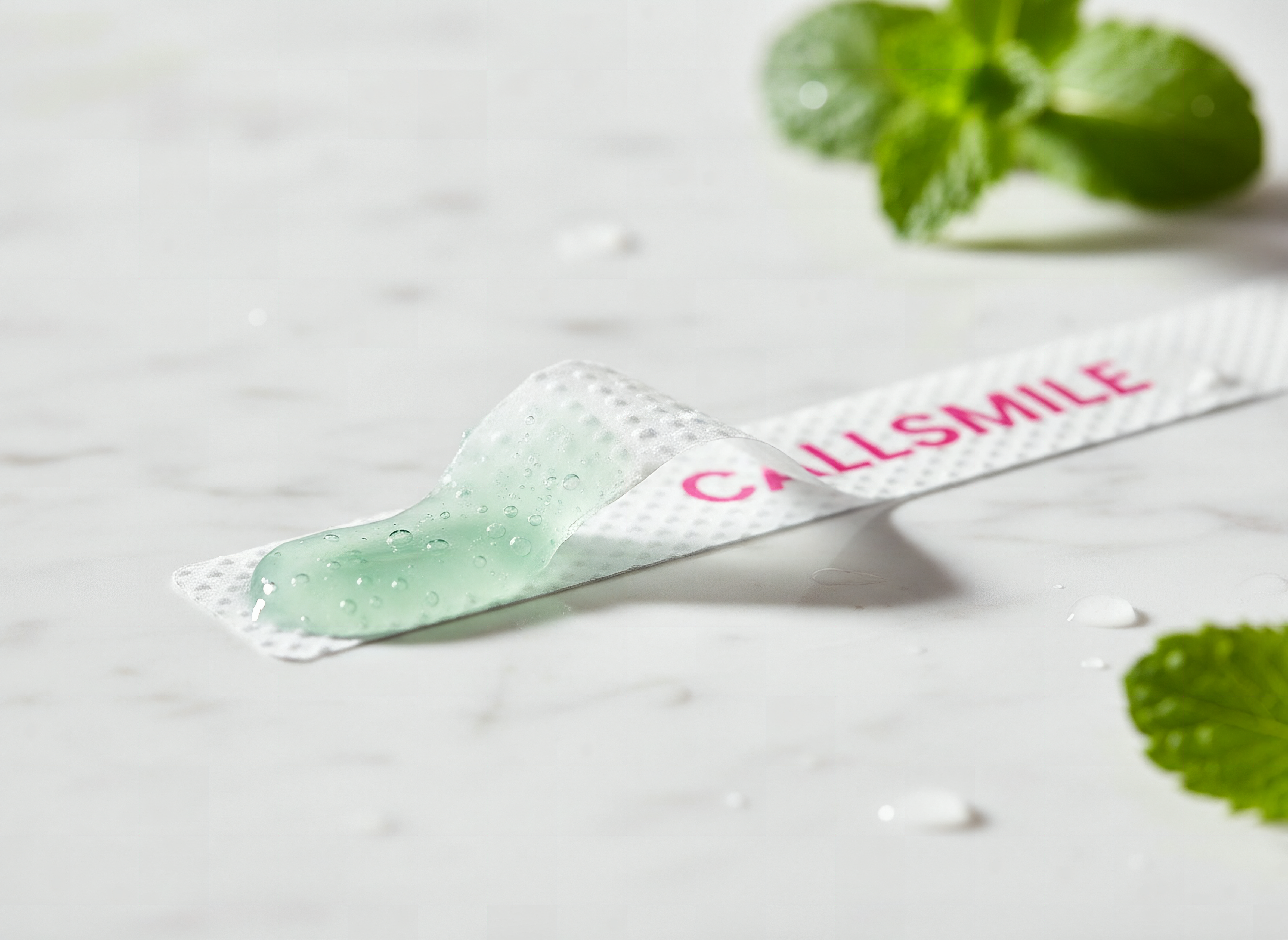 CALLSMILE whitening strip partially peeled, showing mint gel detail in macro close-up