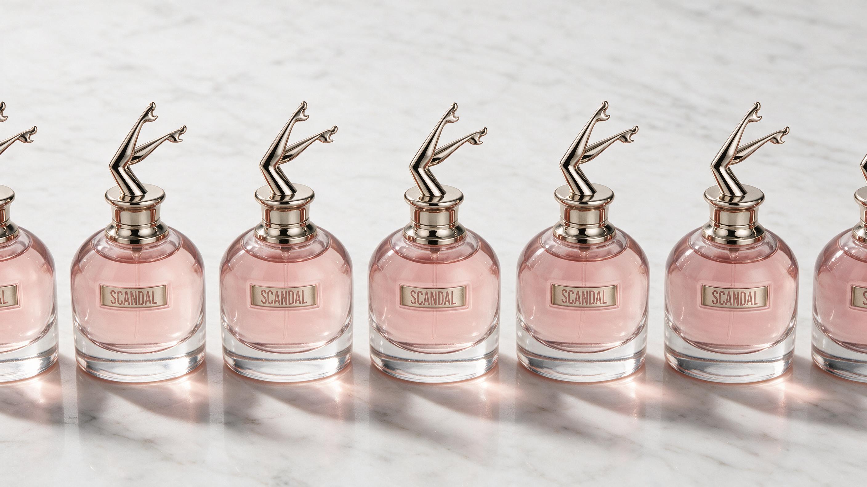 elegant flat lay of several minimalist perfume tester bottles with plain clear glass and simple white labels, arranged i