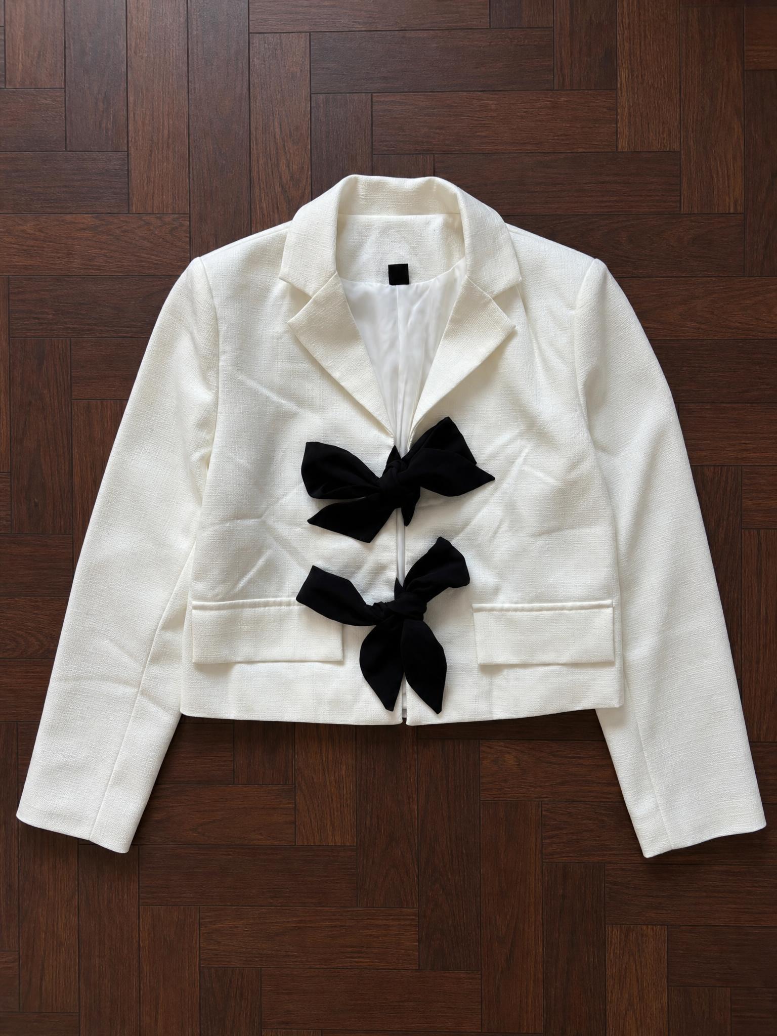 Ivory blazer with black bow details, tailored fit