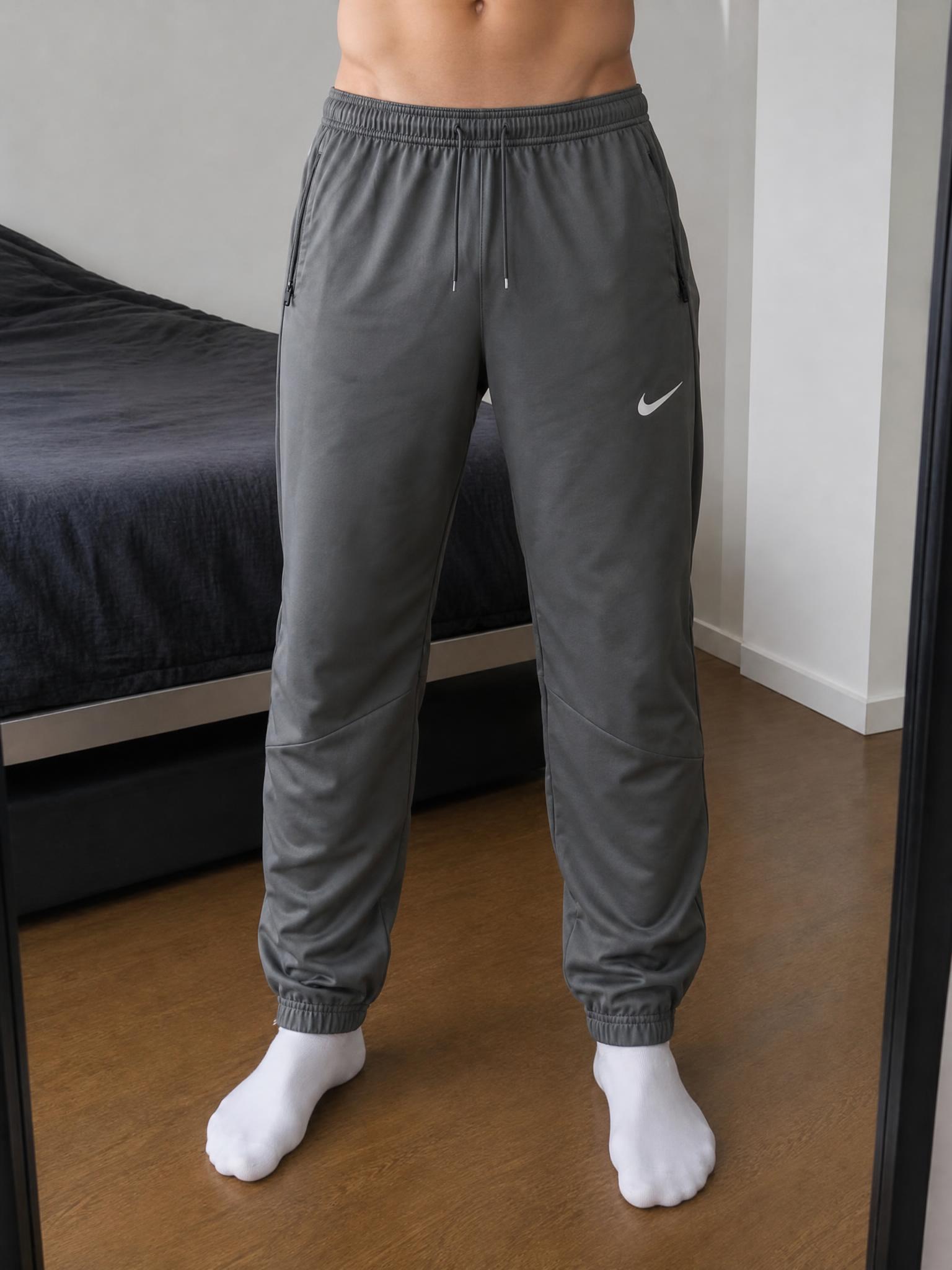 Nike charcoal grey tapered track trousers with zip pockets