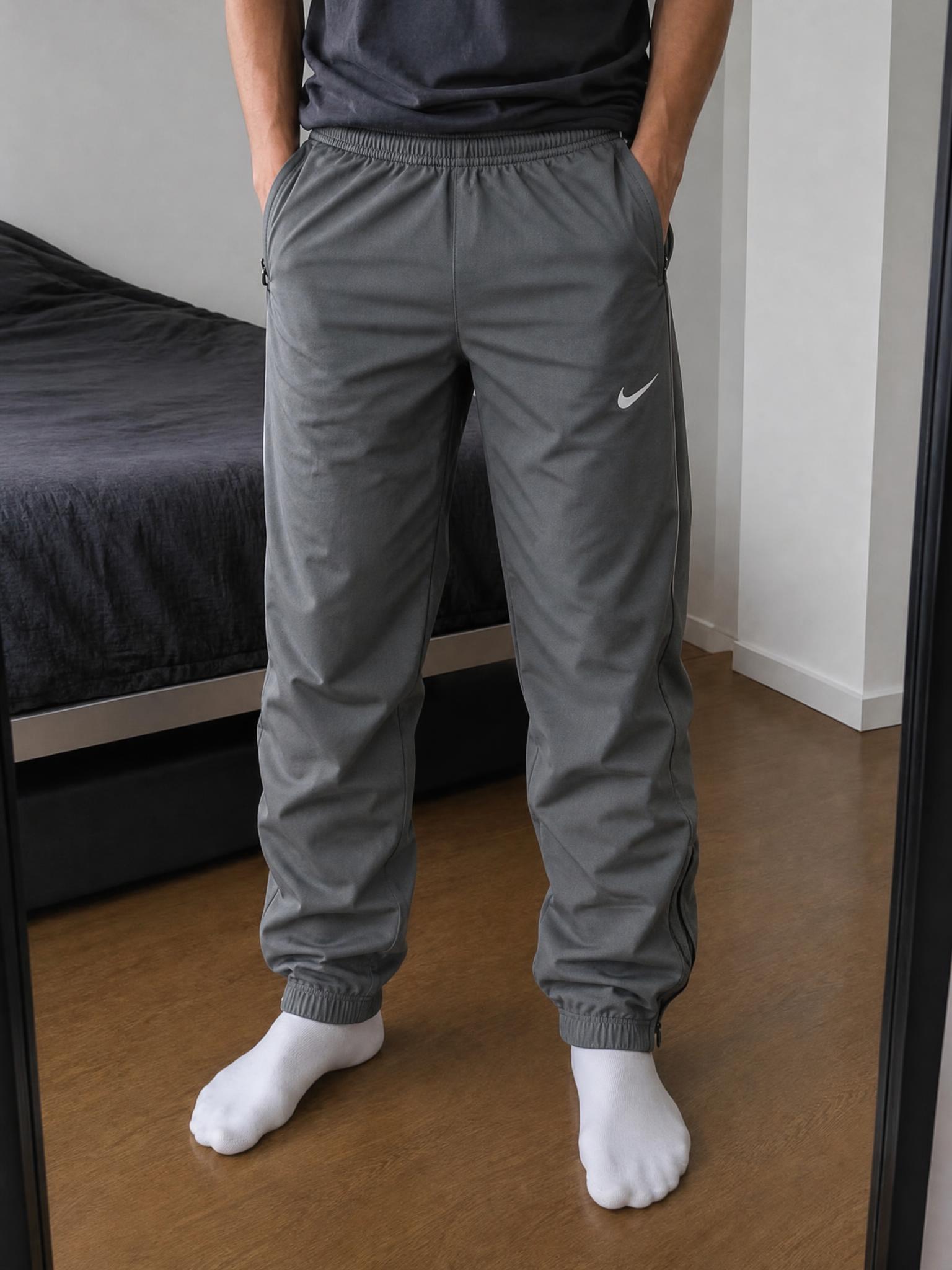 Nike charcoal tapered training trousers with zipped pockets