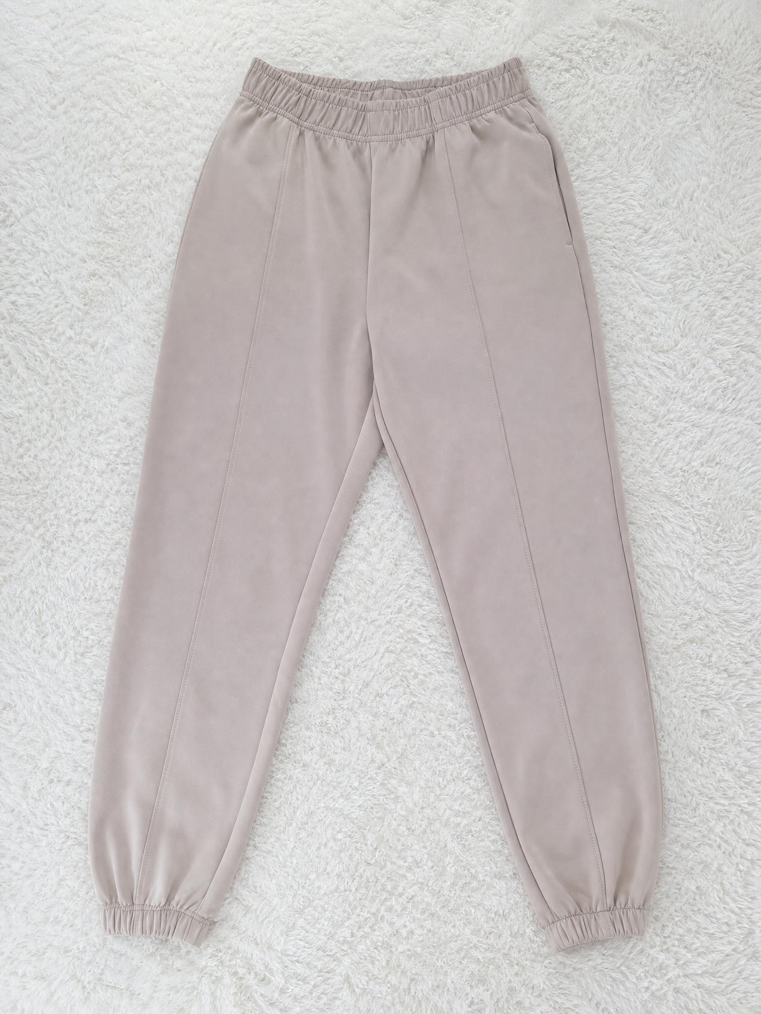 Beige tapered jogger trousers with elasticated cuffs