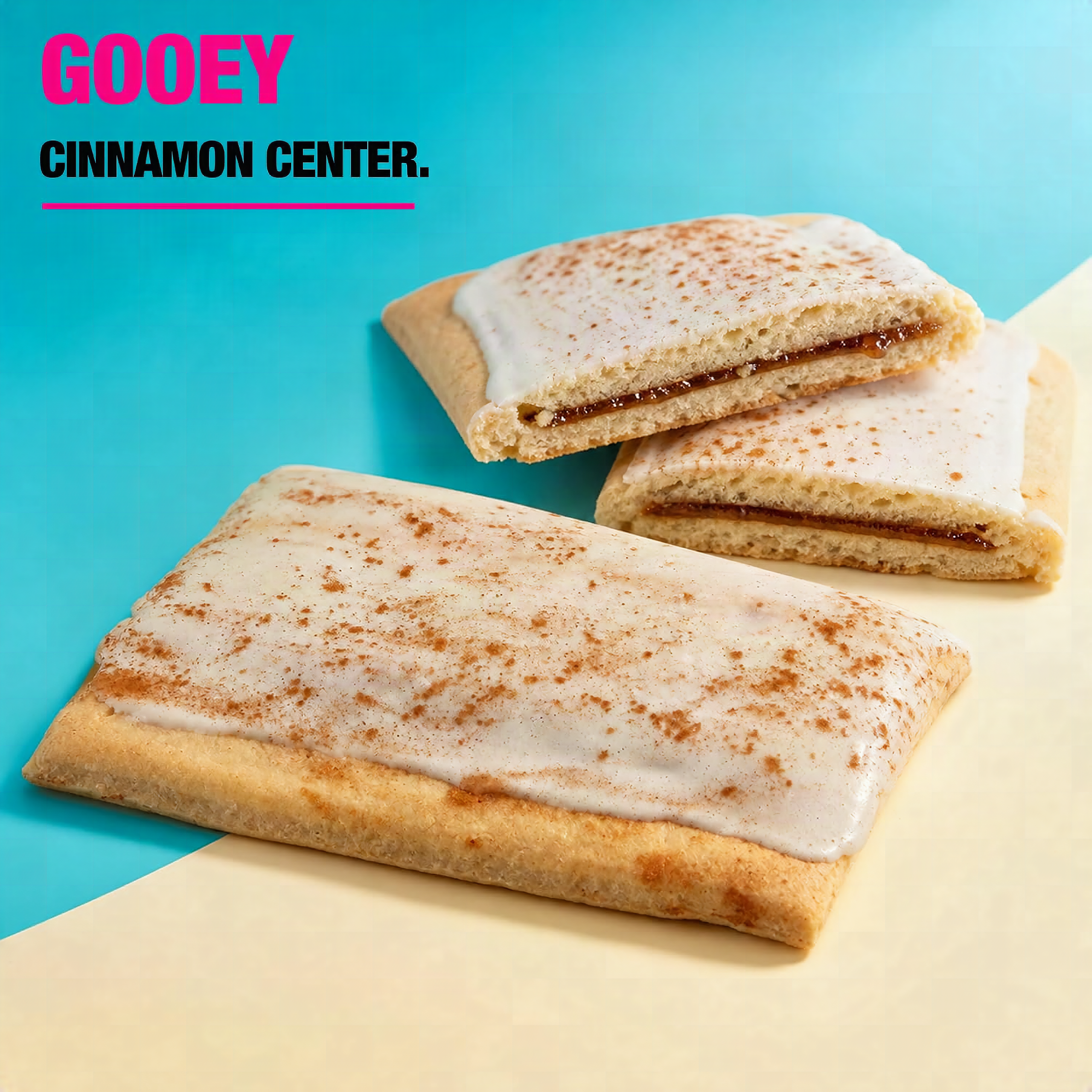 Frosted Cinnamon Protein Pastry broken open showing fluffy interior and cinnamon swirl detail, macro close-up on slate