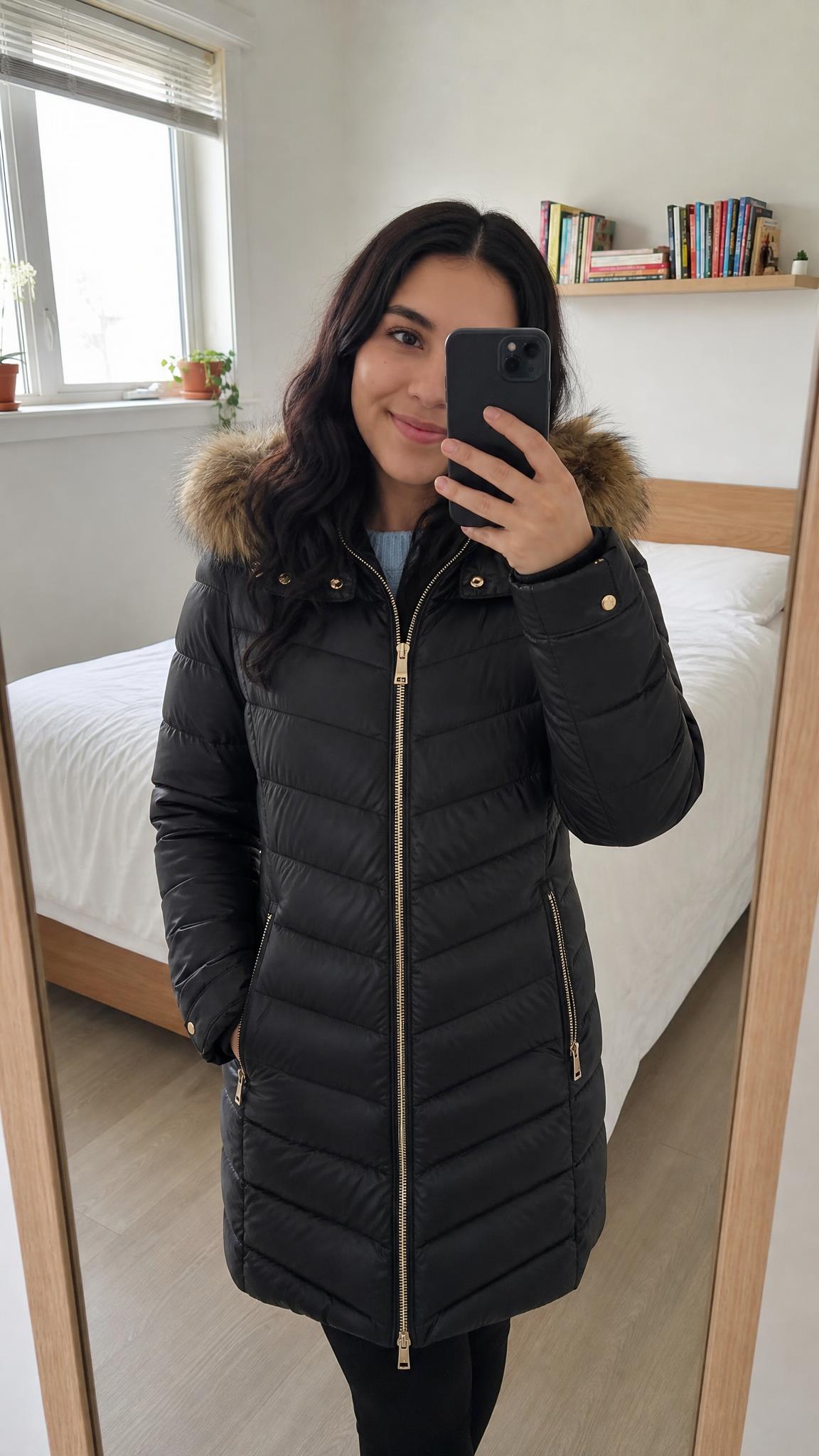 Longline black puffer coat with oversized faux-fur hood