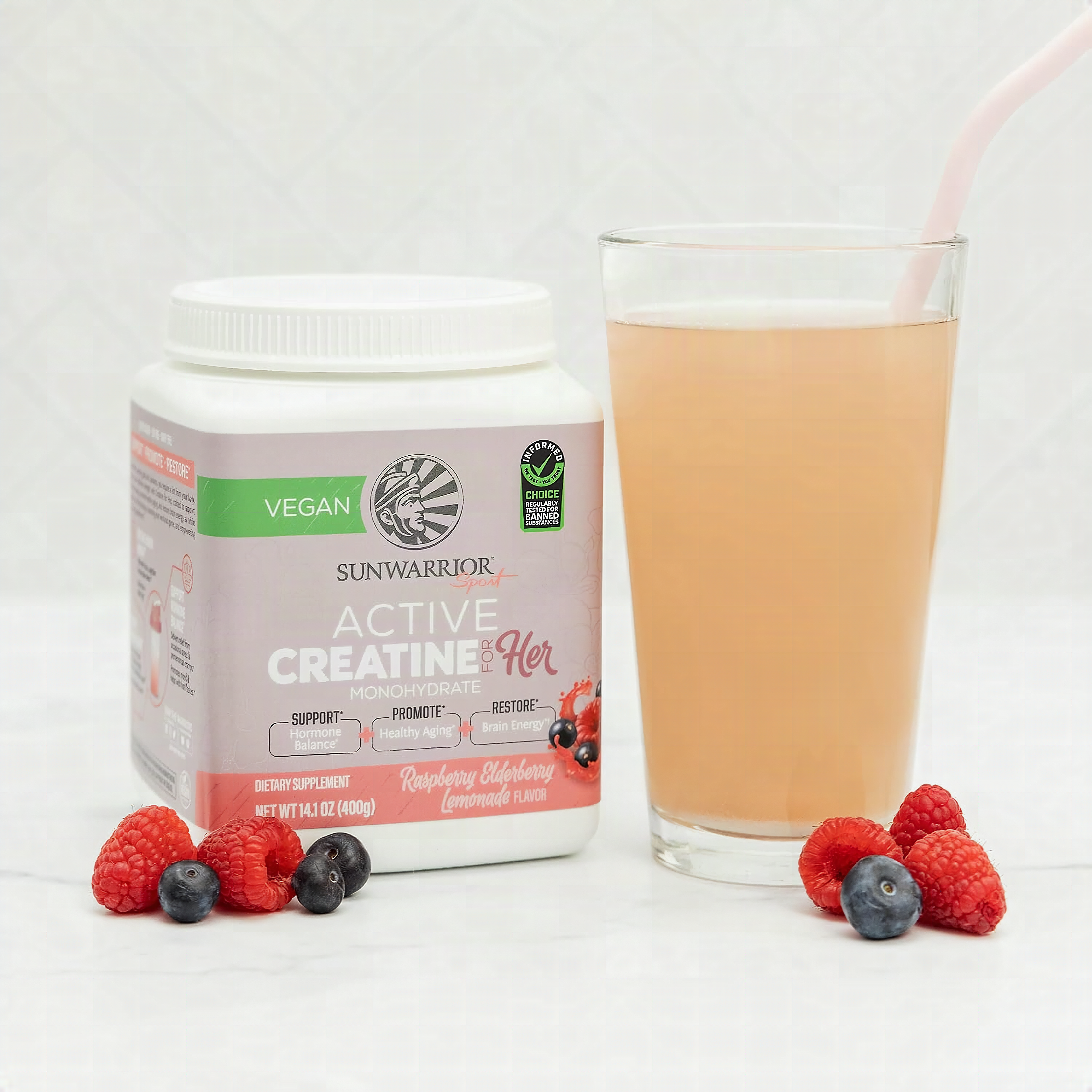 Macro close-up of raspberry lemonade creatine monohydrate powder in a glass scoop, pink granules in sharp focus