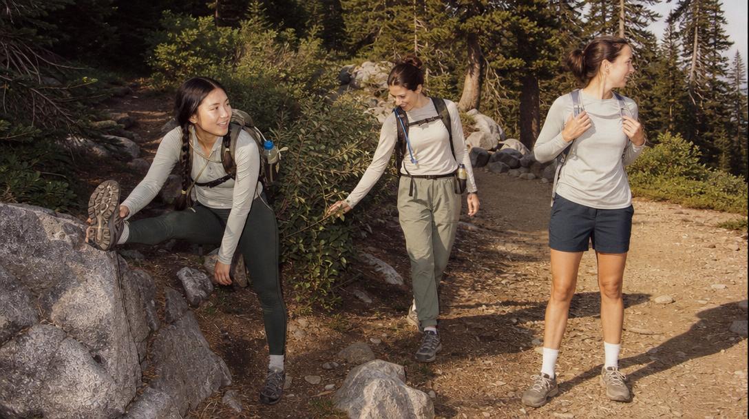 Woman hiking in layered clothing on trail