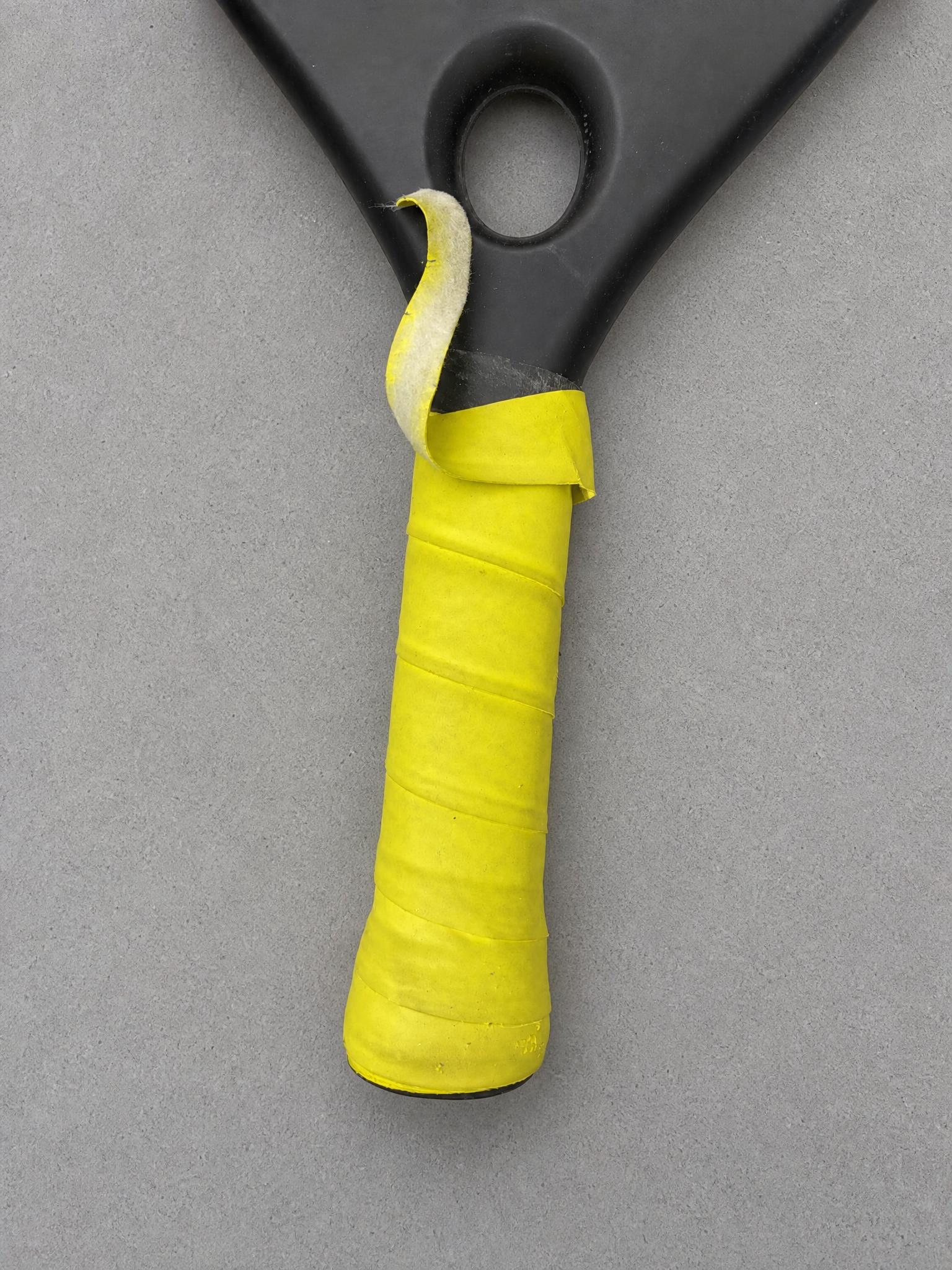 Black & neon yellow sports equipment handle with wrapped grip