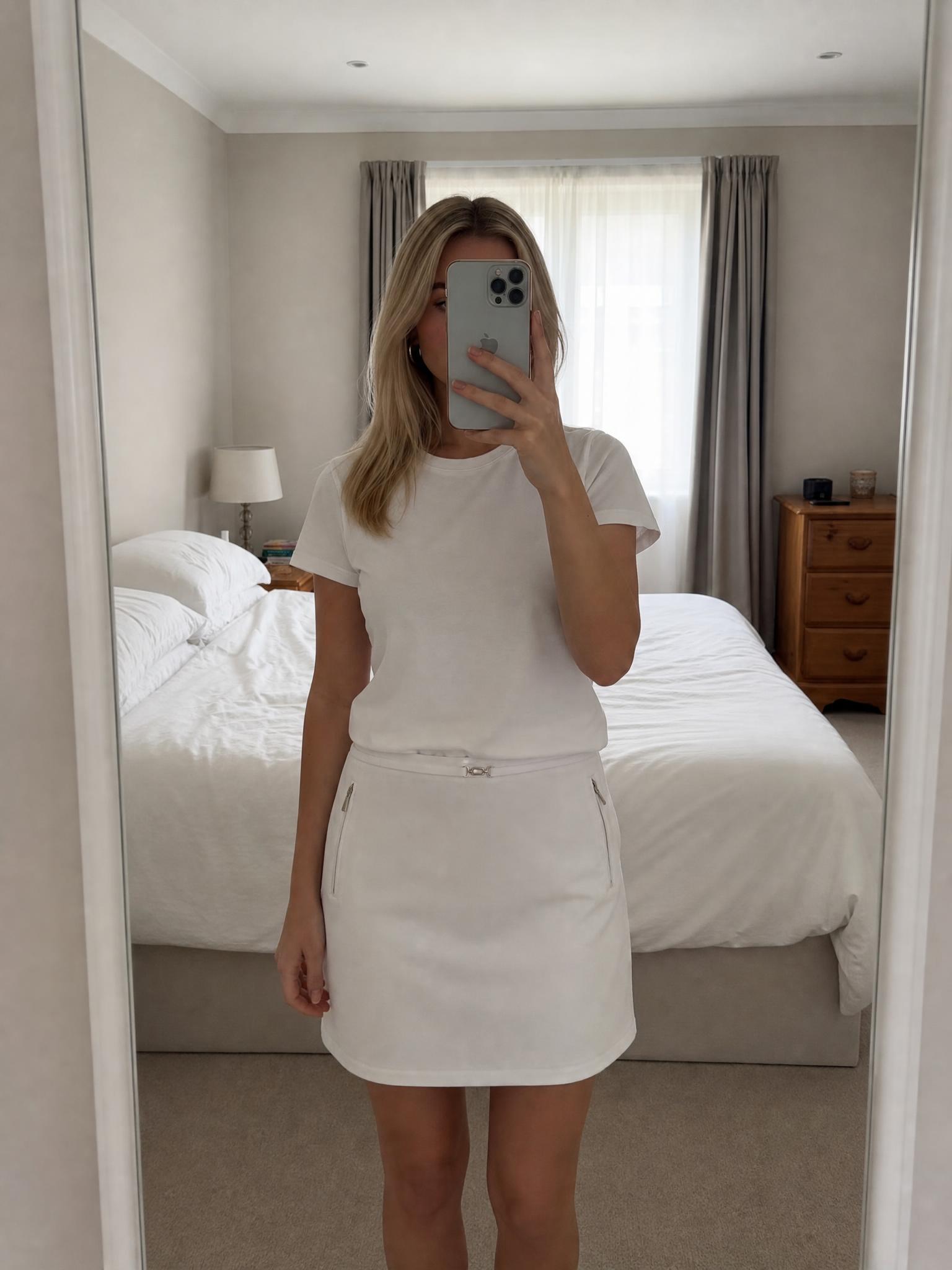White mini skirt with zip pockets and gold-tone details