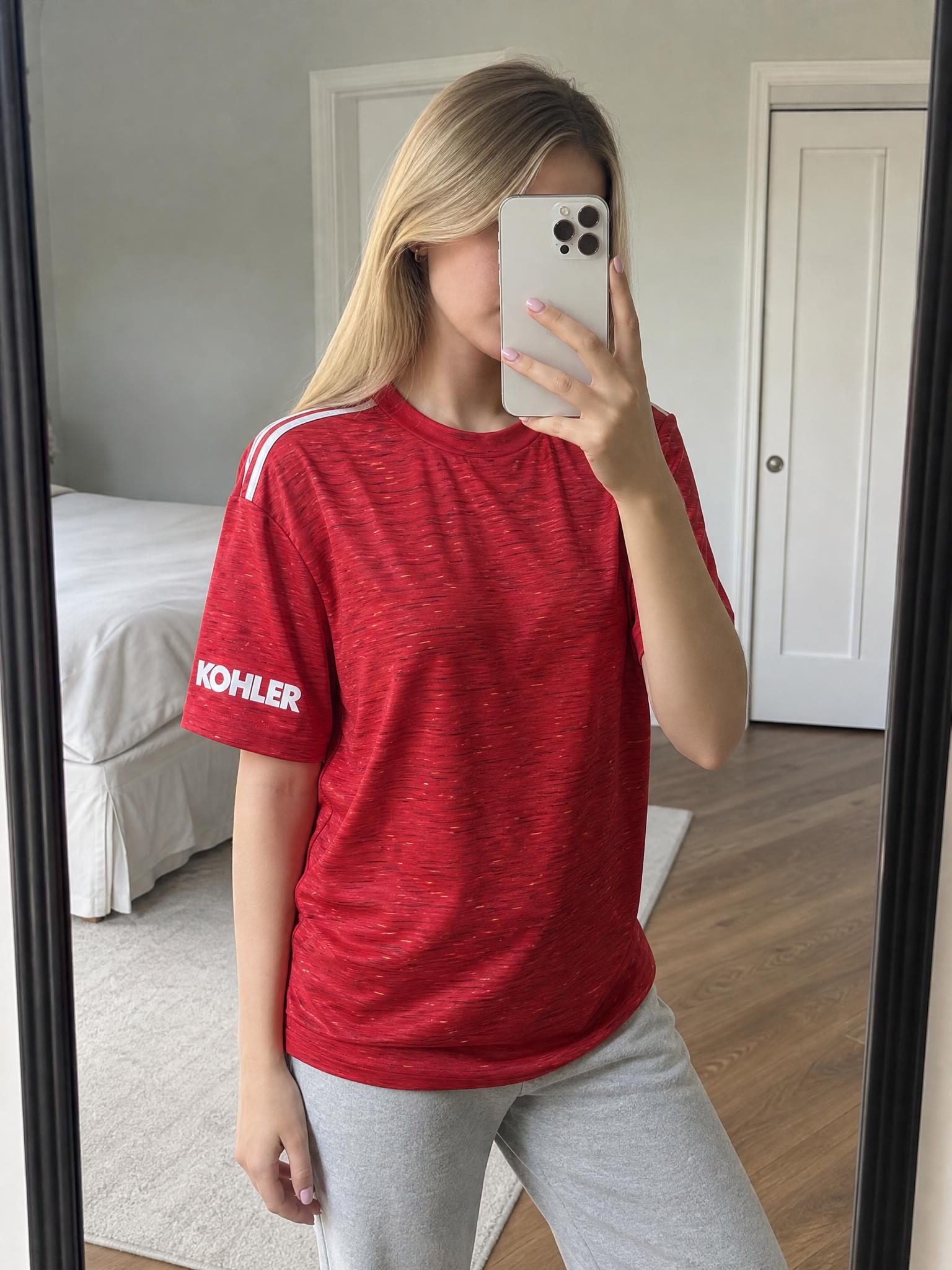 Red football training shirt with white stripes and Kohler sleeve logo