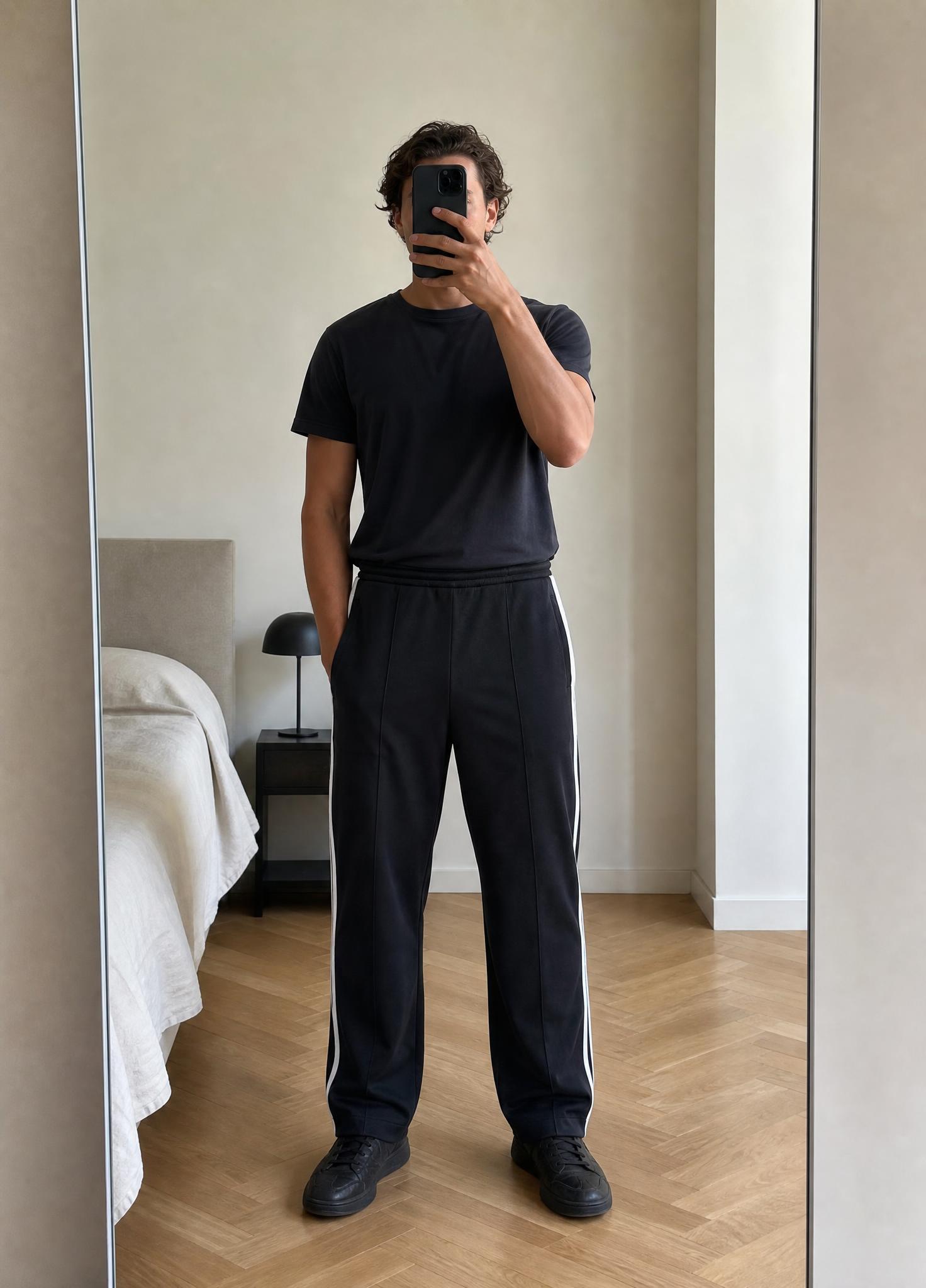 Black athletic trousers with white side stripes – very good