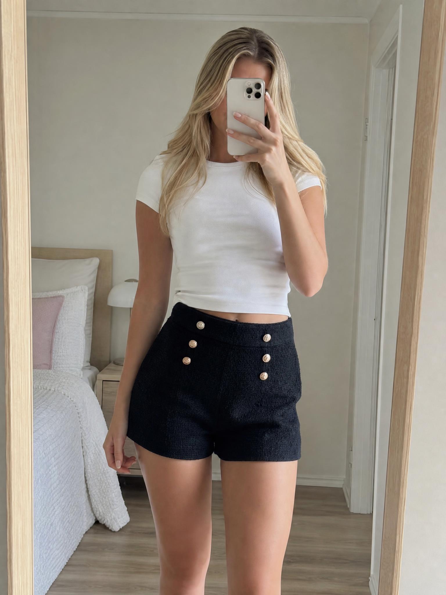 Textured black high-waisted shorts with gold buttons