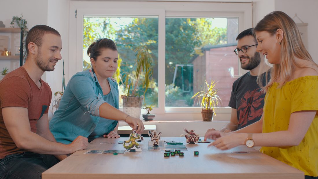 Four players around a game of King of Tokyo
