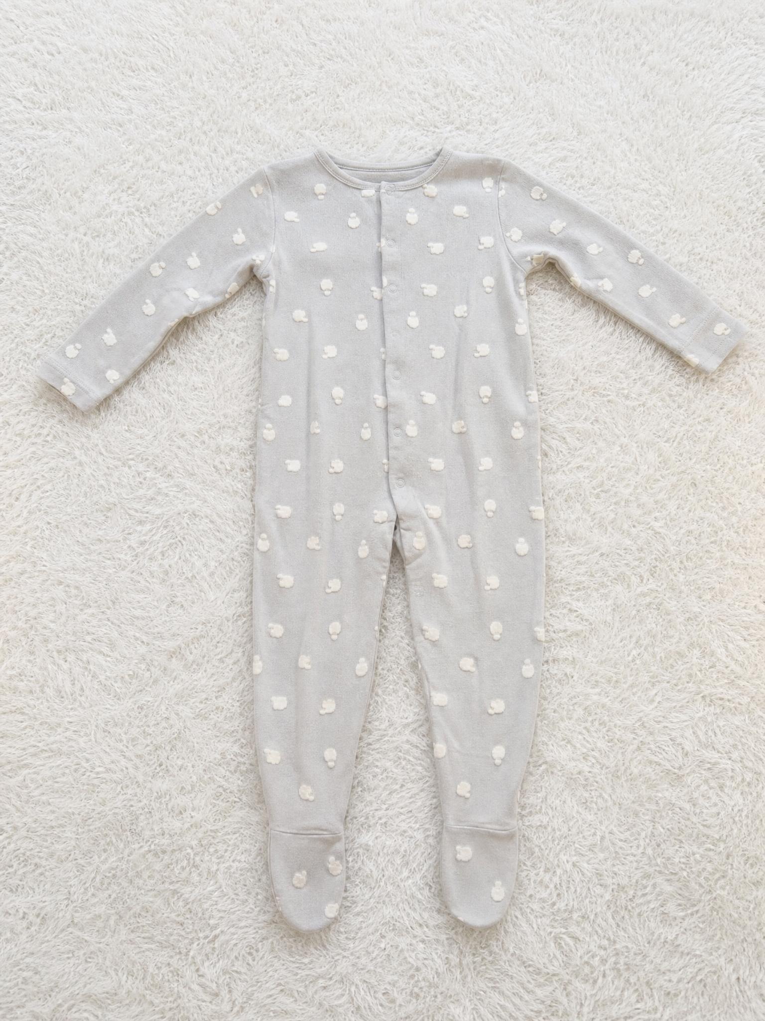 Grey baby sleepsuit with cream animal print and feet