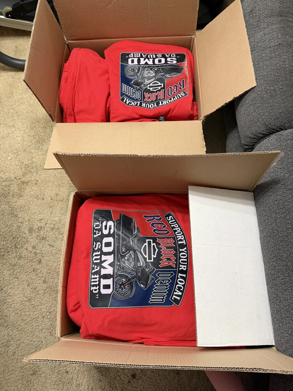 A box of finished printed t-shirts ready for pickup