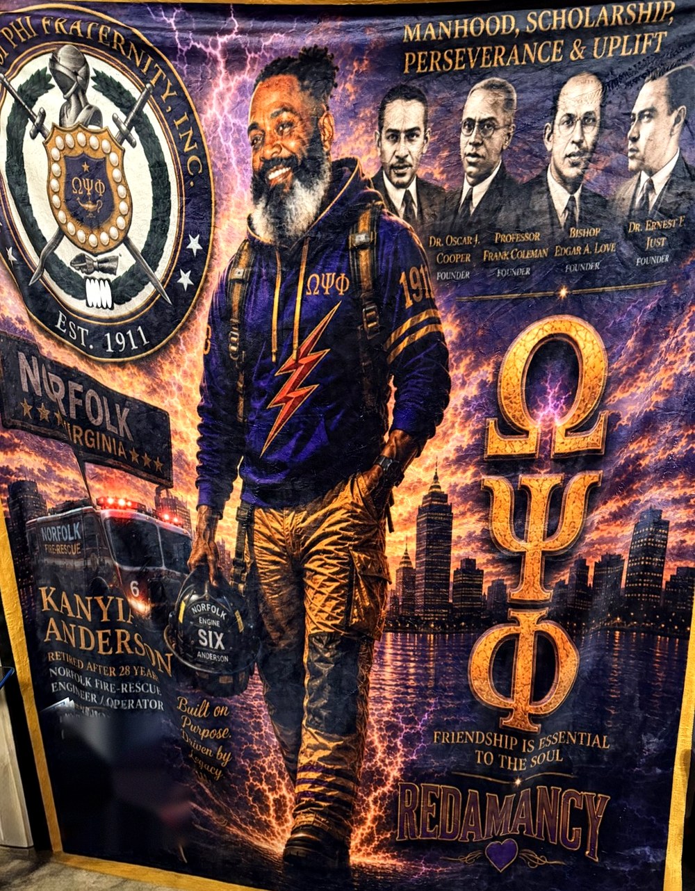 A custom tribute fleece blanket made by Redamancy for Kanyia Anderson, retired Norfolk Fire-Rescue engineer, with the Omega Psi Phi crest, the four founders and a Norfolk skyline
