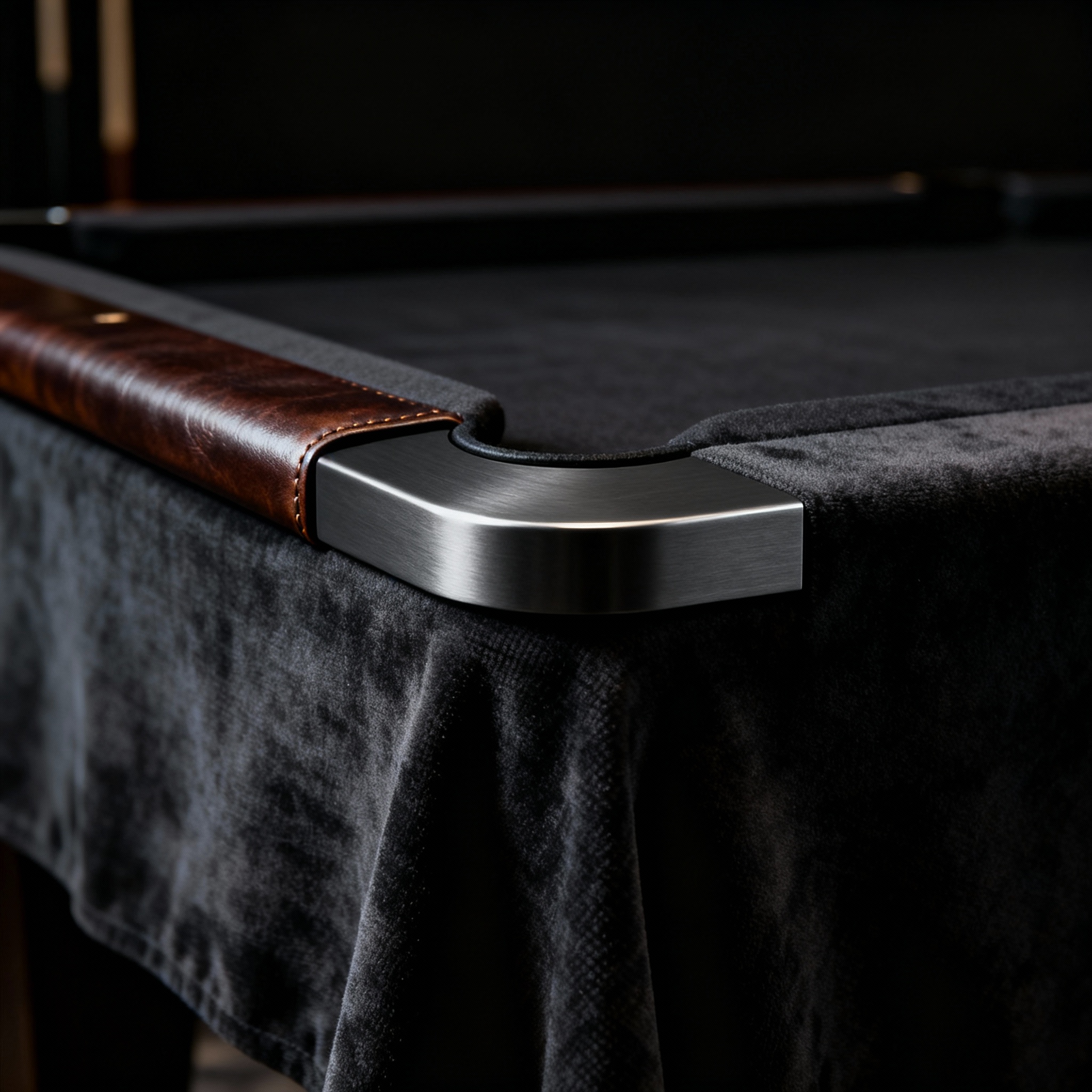 Close-up photorealistic shot of luxury materials, showing a table corner with graphite metal inlay, leather-bound rail, pr...